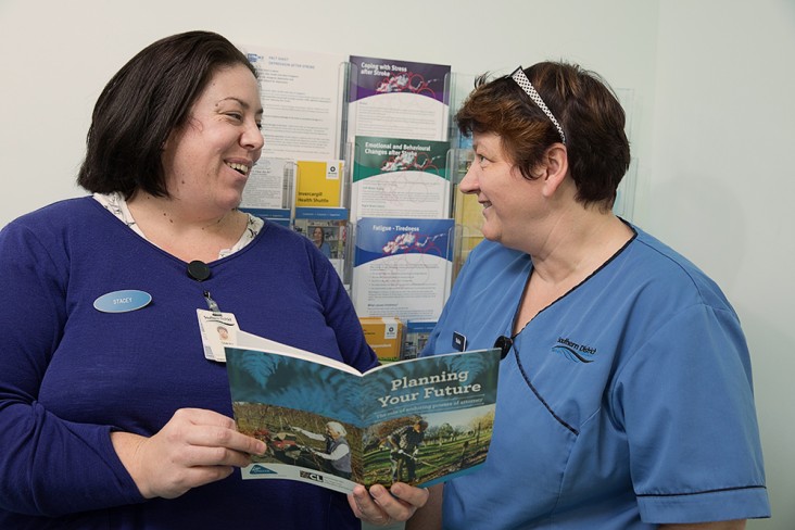 two women looking at health brochures