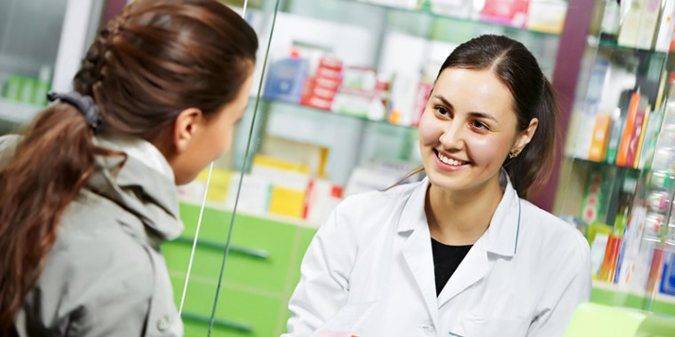 Woman serving customer at a pharmacy