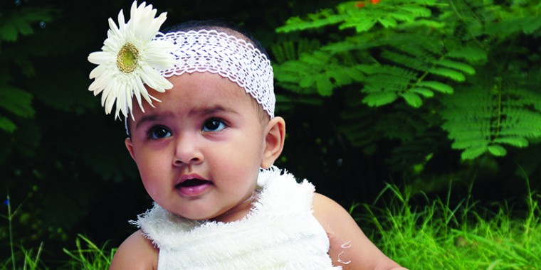 baby with flower in hair