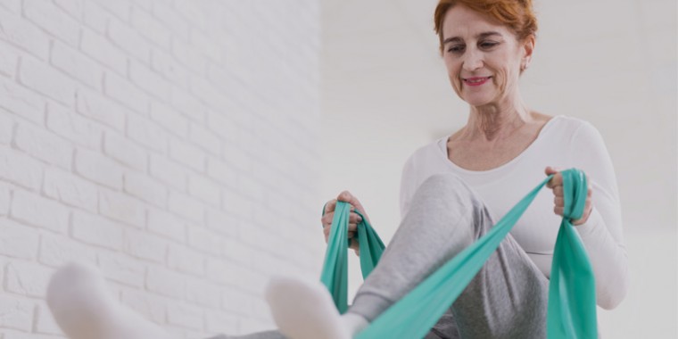 An older woman doing leg exercises