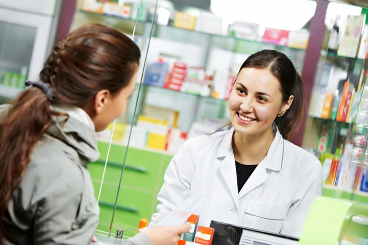 Woman serving customer at a pharmacy