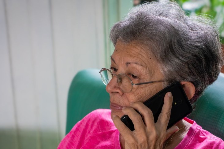 Woman on a cell phone wearing a pink top