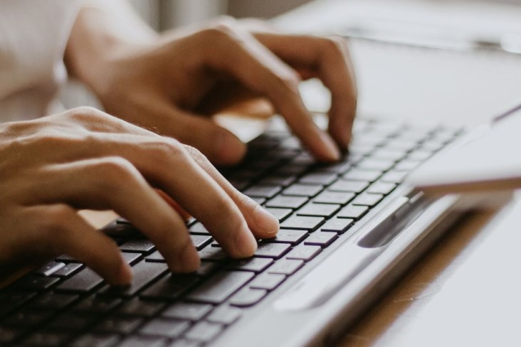 A person typing on a keyboard