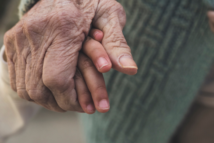Young hand and old hand holding
