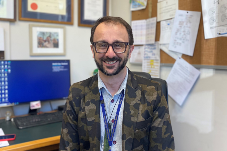 Professor Christopher Jackson sits at his desk in his office