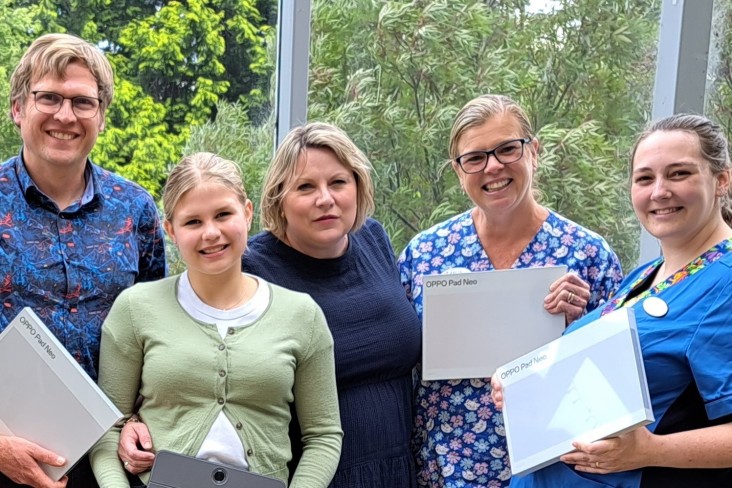 Livia Bradshaw is pictured with her parents Vicky and Harry and healthcare staff holding the computer tablets that have been donated.
