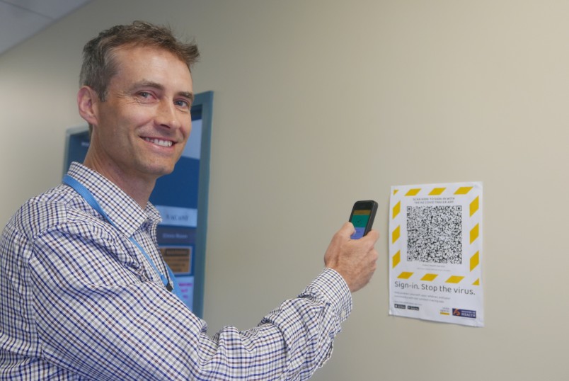 Dr Michael Butchard scanning a QR code